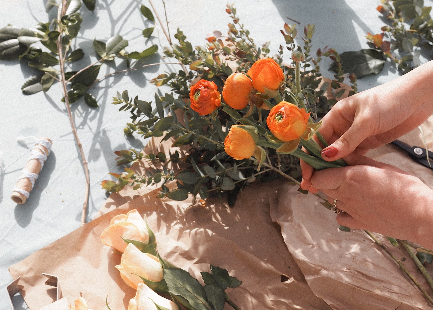 a woman's hands holding orange flowers